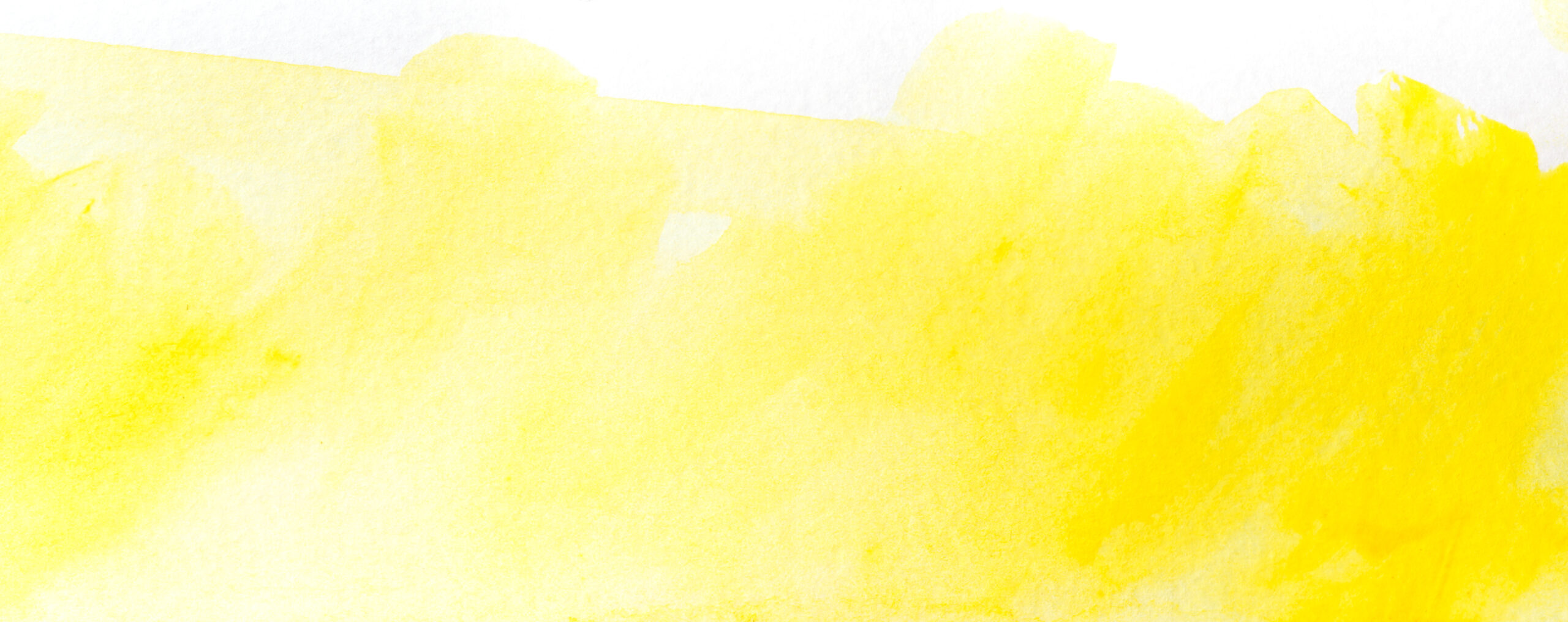 yellow watercolor stain drawn by hand. on paper with texture.